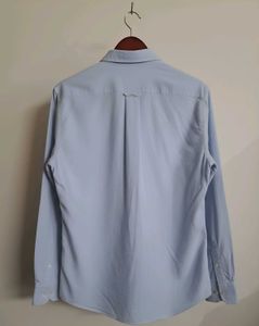 Long-sleeve polo shirt with a button-down collar.