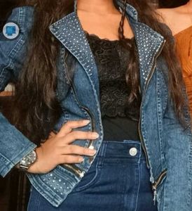 A Denim Jacket With Metallic Star Work On It