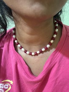 it’s a chain . it’s white and maroon mixed col