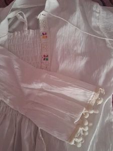 Its A White Top Wear With Multicolor Embroidery