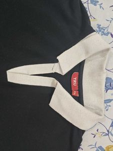 This is a black polo tshirt.With white collar.