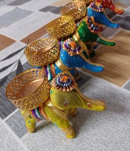 set of five elephants with diya on it