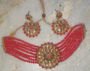 Red  chokar set with earing Base Metal:   Choker and EarringsRed  chokar set with earing  this jwellery set looks beautiful with traditional dress like lehenga saree and suits etc.