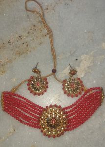 Red  chokar set with earing Base Metal:   Choker and EarringsRed  chokar set with earing  this jwellery set looks beautiful with traditional dress like lehenga saree and suits etc.
