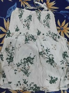 a white body fitted top in flower pattern