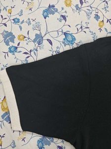 This is a black polo tshirt.With white collar.