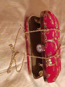 red clutch with zari work