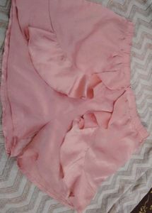 Pretty pastel pink satin shorts with ruffle detail