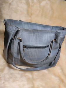A Sophisticated Grey Handbag With Two Handles