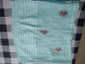 Sky Blue Saree And Blouse  With Red Colour Flower Patches On It With Little Bit Of Stone Work Very Beautiful Saree