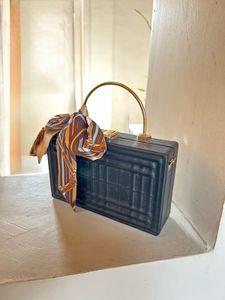 Structured Black Sling Bag with Golden Straps