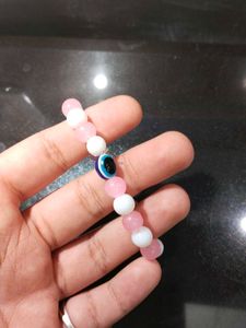 Pink And White Bracelet With An Evil Eye In It