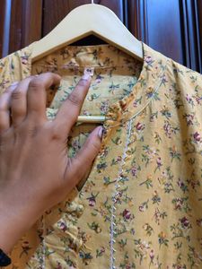 Yellow kurta with a delicate, small floral Print.
