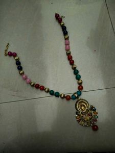 Beaded necklace with golden pendant