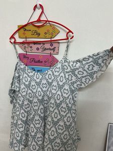 Cold-shoulder top with spaghetti straps.