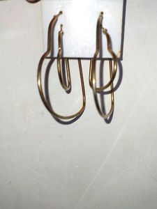 Two Heart Shaped Hoops In Gold .