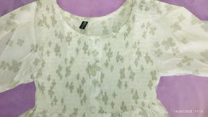 A Ruffled , Smoking Top With Good Sleeves