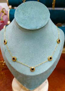 Gold Chain Necklace Featuring black bead or onyx