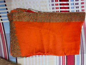 Vibrant Orange Saree with Stone Work and Ornate Em