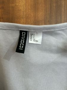 Fitted crop top with button front and scoop neck