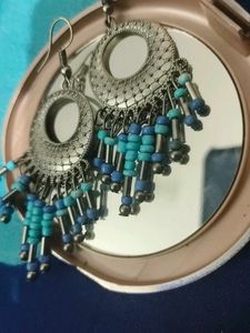 Silver Jhumkas With Blue Beeds.