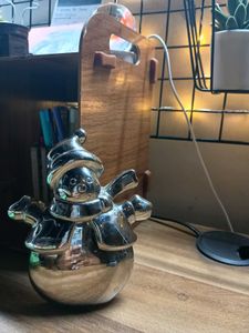 A Shiny Silver Snowman Figurine With Top Hat