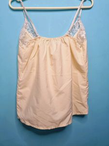 Cream Cami Top With Net Design On Neck.