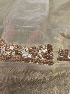 designer blouse piece in soft gold with hand work