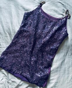 The fabric is covered with small, shiny sequins th