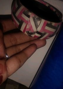 black breslet and a multi colour bangle