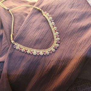 Elegant Gold-Tone Necklace with Red Accents