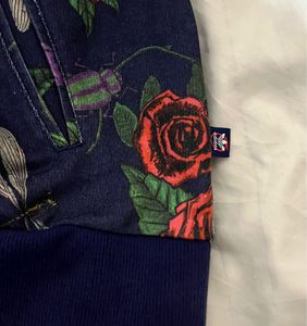 This is an Adidas x Rita Ora navy floral pullover