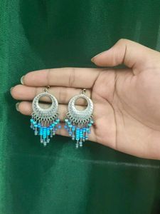 Silver Jhumkas With Blue Beeds.