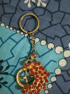 Key Chain In Red Colour With Peacock Design
