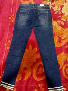 Distressed Jeans with Pom-Pom Hem