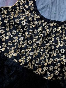 black paplum blouse and grey skirt