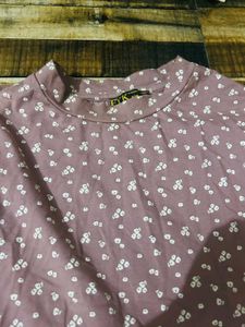 light pink long-sleeved top with a white floral