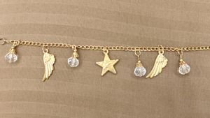 Golden Bracelet With Wings And Star Charms