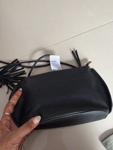 Chic Black Sling Bag with Tassel Detail