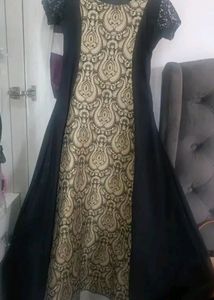 Black gown with cream colour combination. Ideal for parties marriage functions. Have net half sleeves .Stuff is good