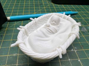 Cradle with baby Jesus for nativity scene