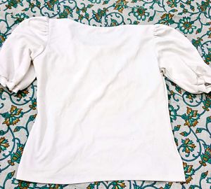 White Puff Sleeve Top With Golden Earrings.