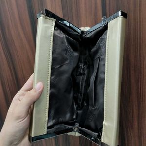NWT Embelle Gold Cluth With Black Metal Sling