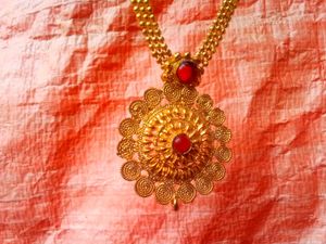 Intricate Gold Tone Filigree Necklace with Red Sto
