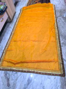Yellow and brown new saree with intact blouse piec