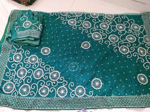 bottle green net saree with blouse and lehnga