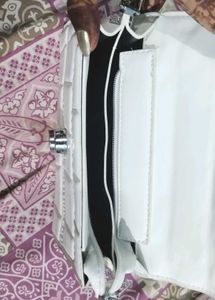white hand purse