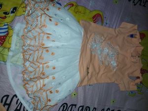 two baby girl dresses are there
