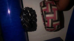 black breslet and a multi colour bangle