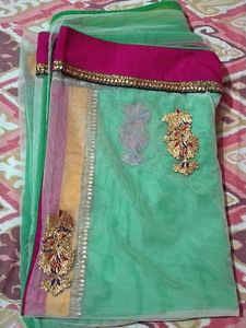 Saree half green and white combination.
